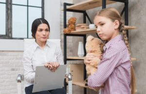 An expert evaluating a child during a counseling session.