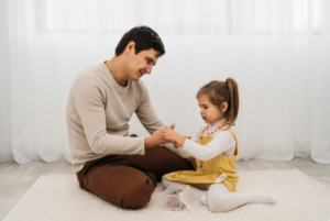 Child playing with father reflecting mood change during transition between homes